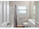 Bright bathroom with a shower-tub combo, white tile, and vanity, plus a window for natural light at 1520 Kirklees Abbey Dr, Charleston, SC 29407