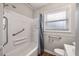 Tidy bathroom showcasing a tub-shower, window, and safety bars for comfortable accessibility at 1520 Kirklees Abbey Dr, Charleston, SC 29407