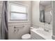Well-lit bathroom featuring a window, shower-tub, white vanity, and accessibility handrails at 1520 Kirklees Abbey Dr, Charleston, SC 29407