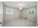 Cozy bedroom with carpet flooring, two windows for ample light, and an elegant pendant light fixture at 1520 Kirklees Abbey Dr, Charleston, SC 29407