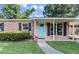Charming brick home with a turquoise door, black shutters, and a well-manicured lawn at 1520 Kirklees Abbey Dr, Charleston, SC 29407