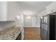 Bright kitchen with granite counters, white cabinets, stainless refrigerator and appliances at 1520 Kirklees Abbey Dr, Charleston, SC 29407