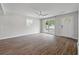 Spacious living room with wood floors, neutral walls, a ceiling fan, and abundant natural light at 1520 Kirklees Abbey Dr, Charleston, SC 29407