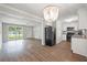 Inviting combined living space with wood floors, modern lighting, and open kitchen concept at 1520 Kirklees Abbey Dr, Charleston, SC 29407