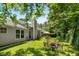 Wide open backyard featuring an outdoor patio table set, chairs, and a fire pit at 170 Danzid Dr, Summerville, SC 29483