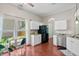 Well lit kitchen with white cabinetry, black appliances, eat in nook, and wood flooring at 170 Danzid Dr, Summerville, SC 29483