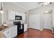 Modern kitchen with white cabinets, black appliances, and hardwood floors at 170 Danzid Dr, Summerville, SC 29483