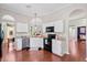 Bright kitchen featuring white cabinets, granite countertops, and modern black appliances at 170 Danzid Dr, Summerville, SC 29483
