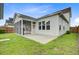Exterior view of home with screened in porch and patio overlooking a large lawn at 176 Midtown Ave, Summerville, SC 29486
