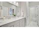 Bright bathroom with dual sinks, framed mirror, and walk-in shower at 176 Midtown Ave, Summerville, SC 29486
