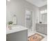 Bathroom with gray double sink vanity, a stylish rug, and an open doorway to the toilet at 176 Midtown Ave, Summerville, SC 29486