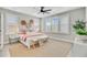 Inviting bedroom with natural light, complemented by neutral tones and decor; ceiling fan included at 176 Midtown Ave, Summerville, SC 29486