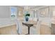 Cozy dining room featuring white seating, stylish lighting, and a view into the home at 176 Midtown Ave, Summerville, SC 29486
