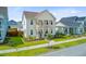 Attractive two-story home with dual porches and verdant landscaping on a sunny day at 176 Midtown Ave, Summerville, SC 29486