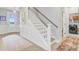 Inviting foyer with staircase, wood-look floors, rug, and access to laundry room at 176 Midtown Ave, Summerville, SC 29486