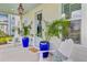 Inviting front porch with blue planters, cozy seating, and stylish decor at 176 Midtown Ave, Summerville, SC 29486