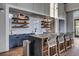 Stylish kitchenette featuring floating shelves and barstool seating at 176 Midtown Ave, Summerville, SC 29486
