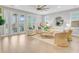 Spacious living room with large glass doors, neutral furniture, wood floors, and a round mirror creating an inviting space at 176 Midtown Ave, Summerville, SC 29486