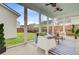 Relax in screened patio with ceiling fans, comfortable seating, and views of the yard at 176 Midtown Ave, Summerville, SC 29486