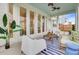 A view of the covered patio with fans and furniture that's perfect for entertaining guests at 176 Midtown Ave, Summerville, SC 29486