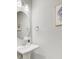 Elegant powder room with pedestal sink, round mirror, and stylish wall art at 176 Midtown Ave, Summerville, SC 29486