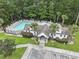 Community pool area featuring a spacious pool, lounge chairs, and a clubhouse surrounded by trees at 192 Buchanan Cir, Goose Creek, SC 29445