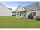 A well-maintained backyard features a covered patio, grill, and green lawn at 192 Buchanan Cir, Goose Creek, SC 29445