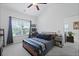 Bright bedroom featuring a large window, a ceiling fan, and a gray and blue color palette at 192 Buchanan Cir, Goose Creek, SC 29445