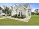 Beautifully maintained townhome, showcasing a well-manicured lawn and planted bushes at 192 Buchanan Cir, Goose Creek, SC 29445