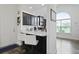 Open kitchen with breakfast bar, white stools, and arched window over the sink at 192 Buchanan Cir, Goose Creek, SC 29445