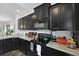 Modern kitchen featuring dark cabinets, granite countertops, and stainless steel appliances at 192 Buchanan Cir, Goose Creek, SC 29445