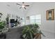 Bright living room with a gray sofa, plants, and a ceiling fan at 192 Buchanan Cir, Goose Creek, SC 29445