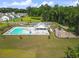 Aerial shot of the community pool, clubhouse, and playground with lush green surroundings and neighborhood homes at 1973 Parish House Cir, Johns Island, SC 29455