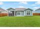 Well-kept backyard features a screened-in porch and a concrete patio at 1973 Parish House Cir, Johns Island, SC 29455