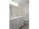 Elegant bathroom with double sink vanity, bathtub and shower combo, offering both style and functionality at 1973 Parish House Cir, Johns Island, SC 29455