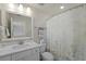 Bright bathroom with decorative shower curtain, featuring vanity with sleek fixtures and ample storage at 1973 Parish House Cir, Johns Island, SC 29455