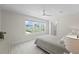 Bright bedroom with three large windows, ensuite bath, and a ceiling fan, perfect for relaxation at 1973 Parish House Cir, Johns Island, SC 29455