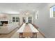 Bright dining room featuring shiplap accent wall, modern lighting, and seamless transition to an outdoor patio at 1973 Parish House Cir, Johns Island, SC 29455