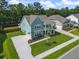 Two-story home with a well-manicured lawn and a charming double porch perfect for relaxing outdoors at 1973 Parish House Cir, Johns Island, SC 29455