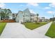 Charming two-story coastal home with a spacious driveway and beautifully landscaped front yard at 1973 Parish House Cir, Johns Island, SC 29455