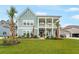 Attractive two-story home with a welcoming front porch and lush landscaping, enhancing curb appeal at 1973 Parish House Cir, Johns Island, SC 29455