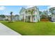 Beautifully landscaped front yard with palm trees, accentuating the curb appeal of this two-story home at 1973 Parish House Cir, Johns Island, SC 29455