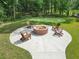 Inviting backyard fire pit area with Adirondack chairs, perfect for entertaining friends and Gathering outdoors at 1973 Parish House Cir, Johns Island, SC 29455