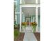 Inviting covered front porch adorned with potted plants, adding a touch of charm to the home's entrance at 1973 Parish House Cir, Johns Island, SC 29455