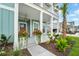 Charming front porch with vibrant planters, enhancing the welcoming entrance to this two-story home at 1973 Parish House Cir, Johns Island, SC 29455