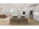 Contemporary kitchen features an island with seating, pendant lights, stainless steel appliances, and white cabinetry at 1973 Parish House Cir, Johns Island, SC 29455