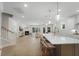 Open-concept kitchen with a large island, pendant lighting, modern appliances, and hardwood floors at 1973 Parish House Cir, Johns Island, SC 29455