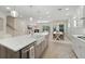 Bright, open kitchen with quartz countertops, stainless appliances, and seamless flow to dining and living areas at 1973 Parish House Cir, Johns Island, SC 29455