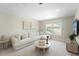 Cozy living room with plush sectional sofa, neutral tones, and a decorative coffee table for relaxation at 1973 Parish House Cir, Johns Island, SC 29455