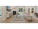 Bright living room offering a fireplace, contemporary furnishings, and open sightlines to dining area at 1973 Parish House Cir, Johns Island, SC 29455